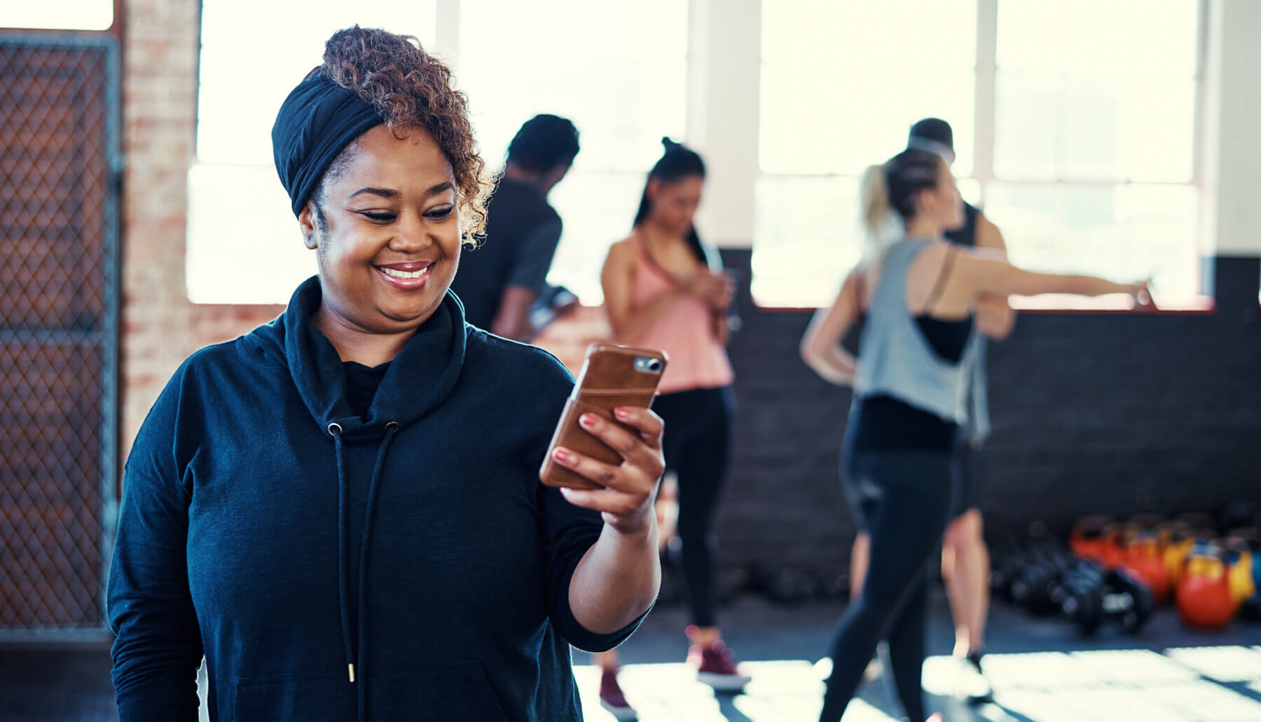 Woman looking at her phone in a gym