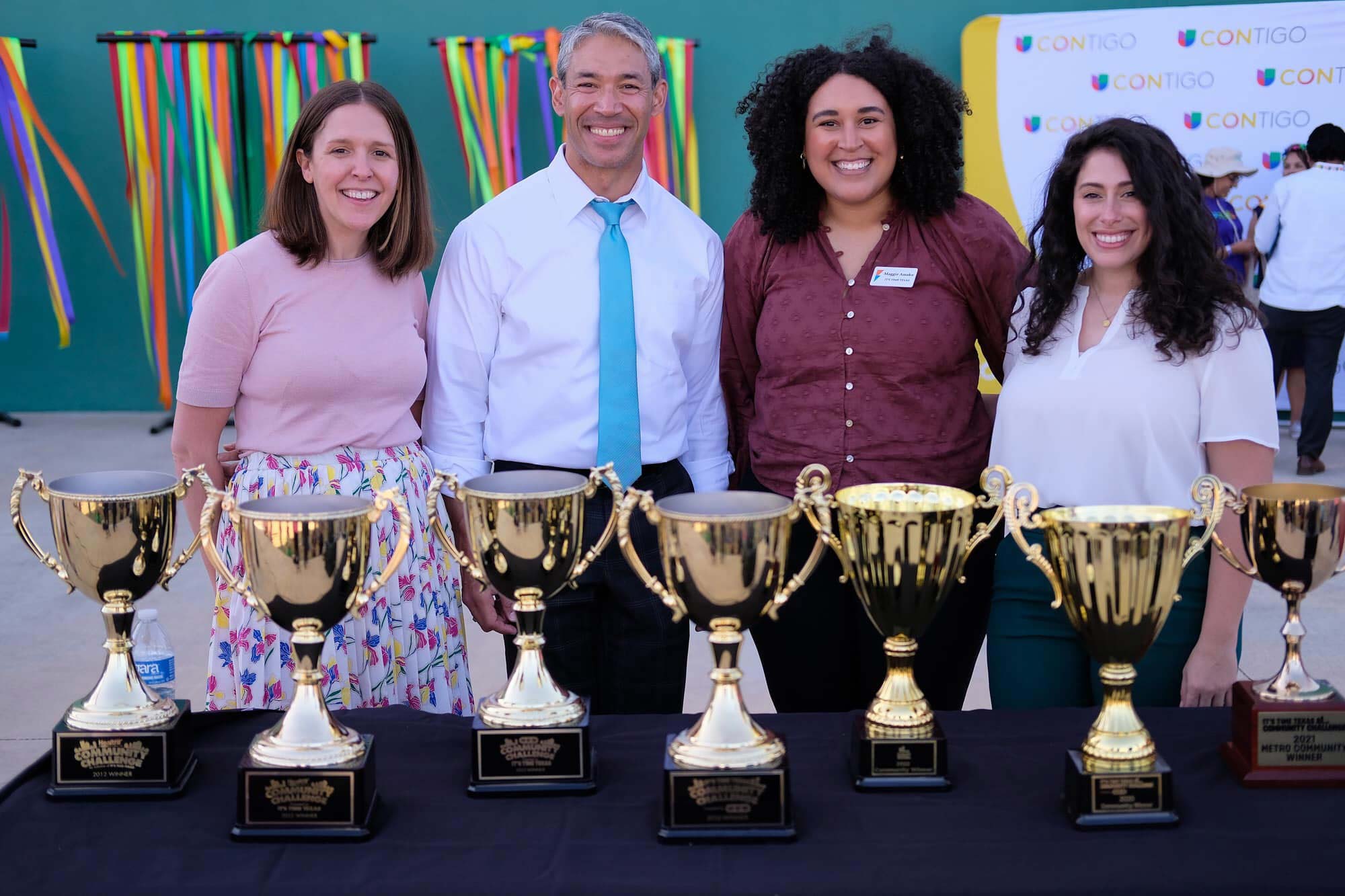 San Antonio Mayor Ron Nirenburg posing for a photo with the Community Challenge winners trophies